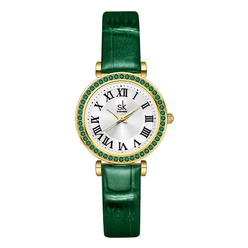 Green watch with gold accents on a white background