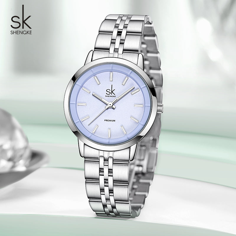 Silver watch with light blue face on a white background, featuring the brand 'Shengke'.
