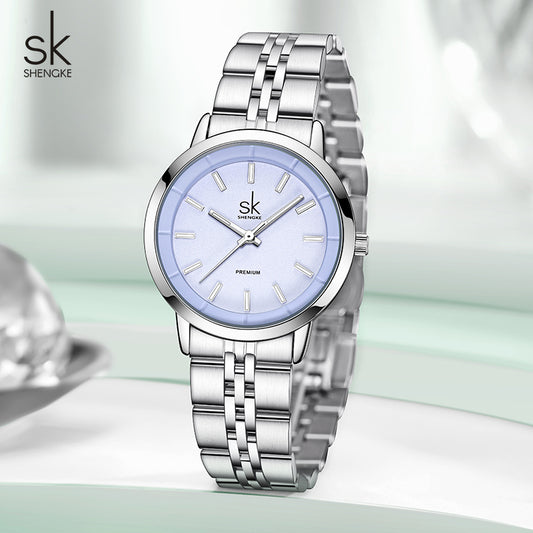 Silver watch with light blue face on a white background, featuring the brand 'Shengke'.