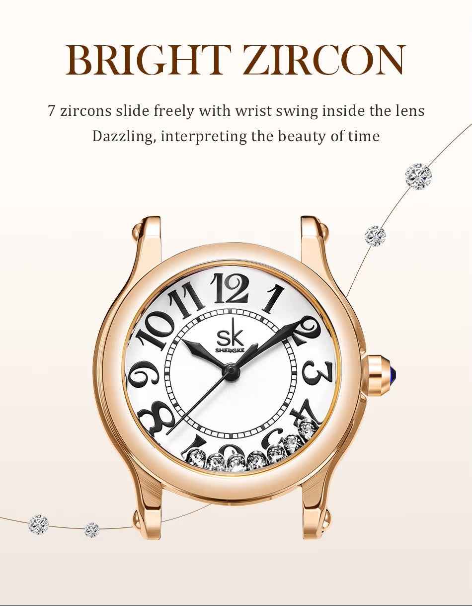 Gold watch with white face and diamond accents on a light beige background