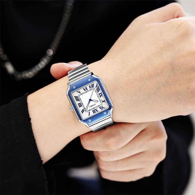Luxury watch with blue accents on a person's wrist against a dark background