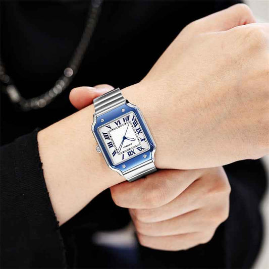 Luxury watch with blue accents on a person's wrist against a dark background