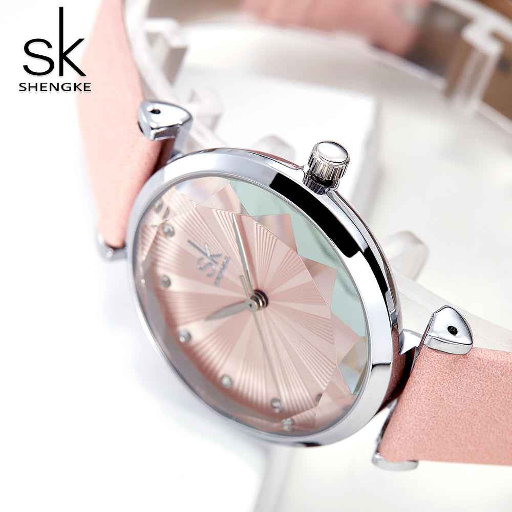 Shengke watch with pink strap and silver gold dial on a white background