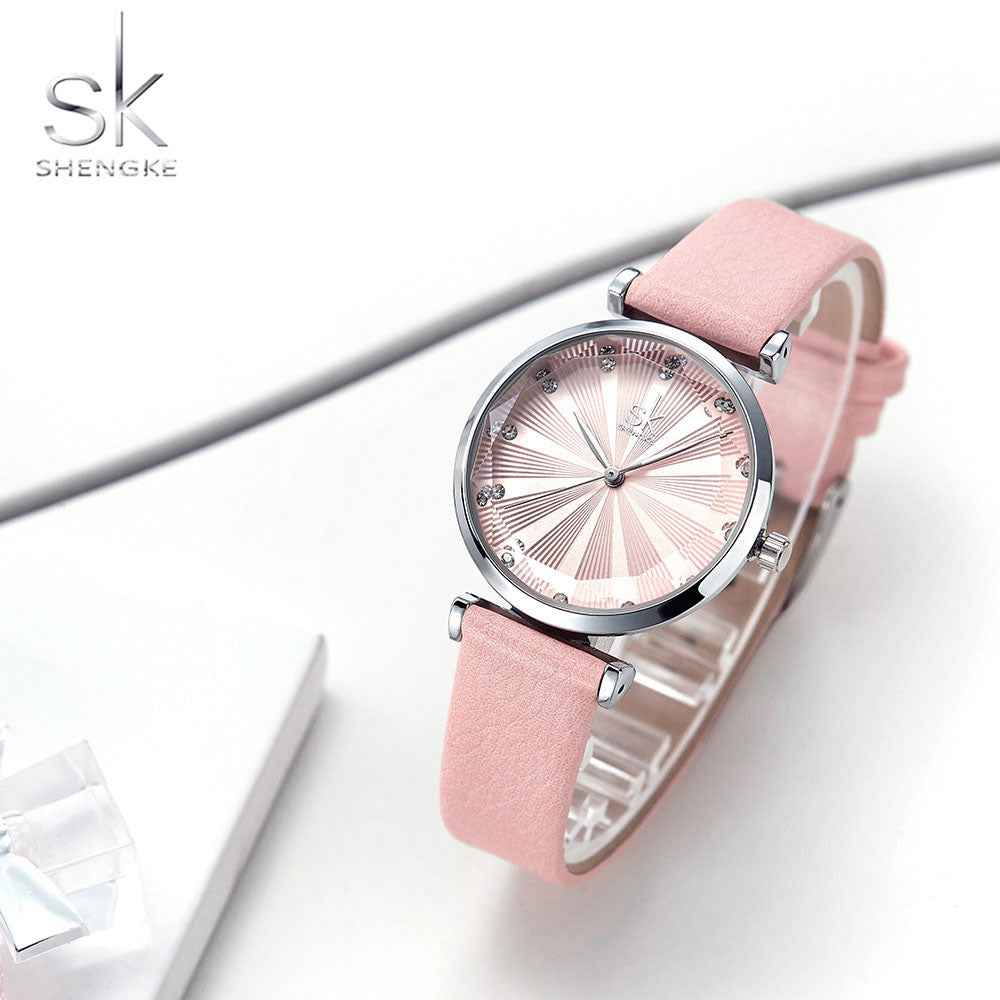Pink watch with a silver case on a white background, featuring the Shengke brand.