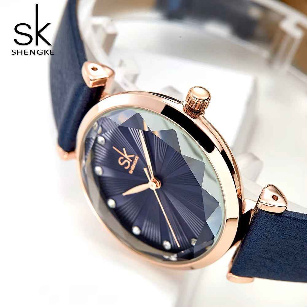 Shengke watch with black strap and gold casing on a white background