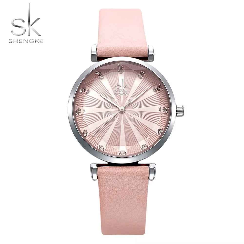 Shengke watch with pink strap and silver gold dial on a white background